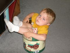 youngest being stuck in a lincoln log bucket