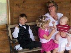 Daughter's mother-in-law at wedding with her 3 grandchildren.
