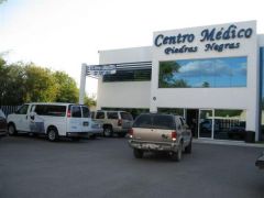 Clinic & the white van that transports patients to and from San Antonio