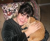 This is me Christmas 2006.  This is my cat Hobo.  We adopted him when someone left him in his cat carrier at the dump.  What type of a person would do that is beyond me but I love this crazy cat.