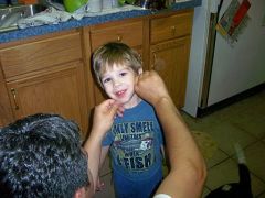 Another picture of Logan, getting his face washed after finger painting.  No kidding, he was PO'ed till I broke out the camera, then he started cheesing.  lol