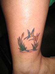 MY TATTOO: Humingbird w/ a lilly and cat tail flower. Myself, mother, aunt, and cousin got this recently in remembrance of my Nanny who died in 2001.