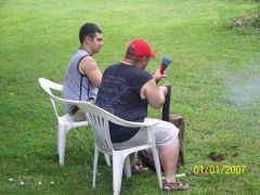 The boys shooting off bottle rockets.