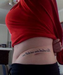 Got this done at Jade Dragon Tattoo in Chicago, IL in 2006.  It says "that which does not kill me..." and is in between 2 of the scars from having a double nephrectomy (kidneys removed) when I was younger.