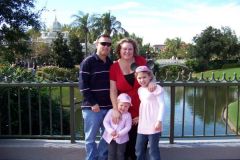 My husband and I with our girls while at Disney