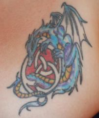 My first tattoo - a dragon wrapped around a celtic knot...located on the left side of my chest.